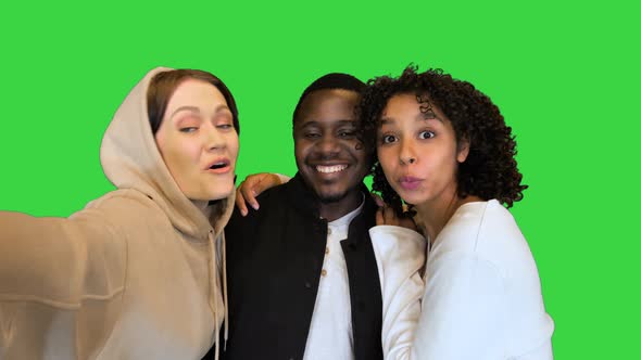 Three Happy Mixed Race Friends Taking a Selfie on a Green Screen Chroma Key