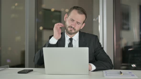 Tired Young Businessman Having Neck Pain at Night 