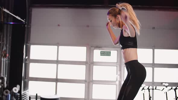 Determined Female Athlete Exercising At Fitness Studio