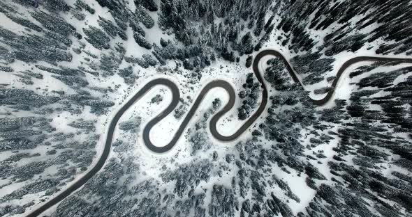 AERIAL: Road in Forest with snow in Dolomites