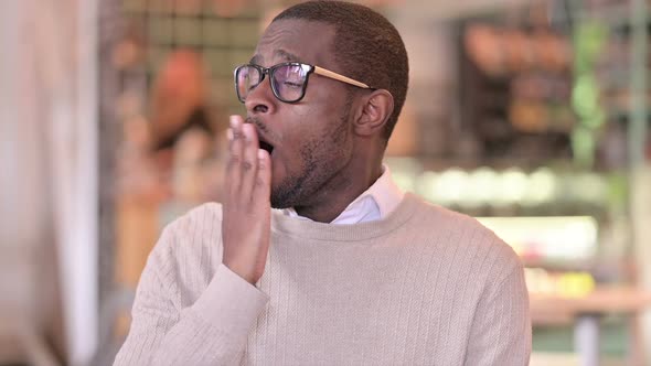 Portrait of Sleepy Young African Man Yawning