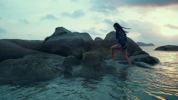 Cute Asian Girl Walking in the Sea at Beautiful Sunset in Slow Motion Thailand