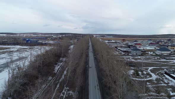 Aerial view of a cars drives along a road near the cottage village 05