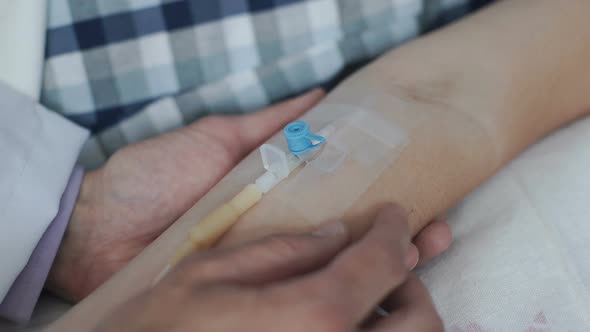 The Doctor Installs a Catheter to a Woman Who is in the Hospital