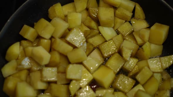 Top View Closeup Potato Frying on Cooking Pan in Kitchen Indoors