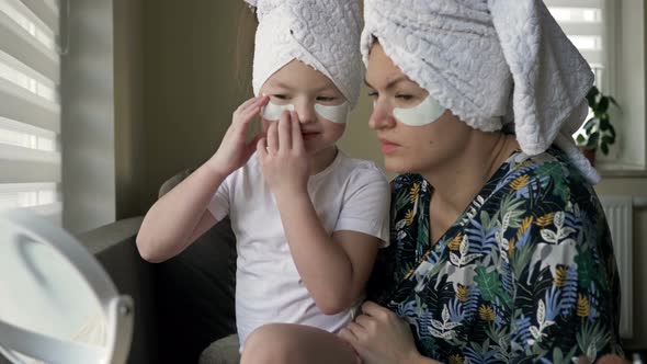 Young Woman and Her Little Daughter Are Doing Beauty Treatments After a Shower