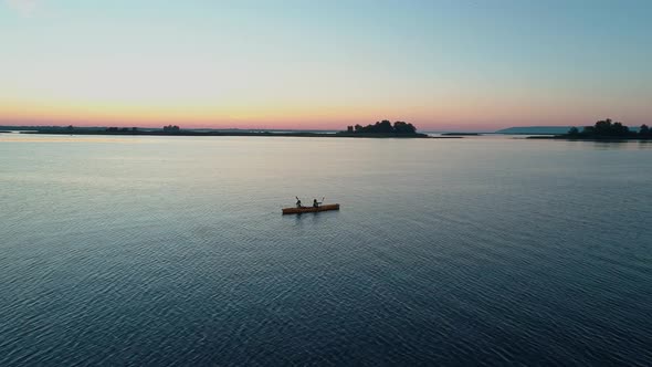 Aerial Drone Footage. Tourists Are Kayaking. Beautiful Sunrise Over River