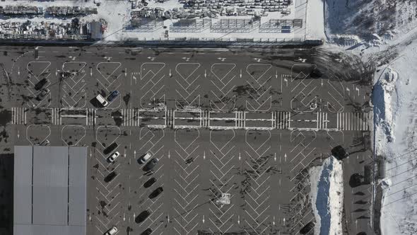 Parking with Cars Near the Big Supermarket  Aerial Shot on a Winter Day