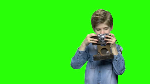 Little Boy Using Old Vintage Photo Camera