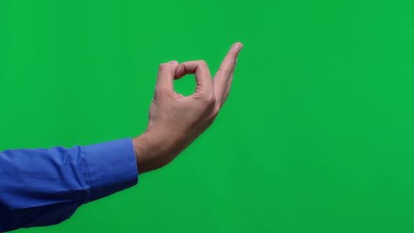 Close Up Man Male Hand Showing OK Sign Okay Gesture Isolated on Green Background Studio