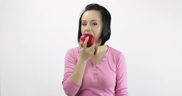 Young Woman Eating Apple and Says Yum. Girl Takes First Bite and Say Wanna Bite