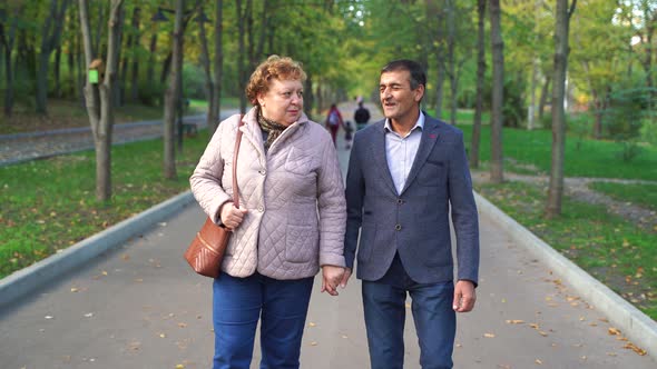 Middle Aged Couple Walking in Park