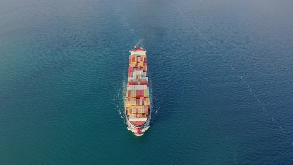 Aerial Top View Drone Flies Over to Large Cargo Ship