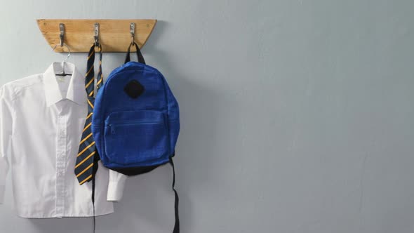 School uniform and school bag hanging on hook 4k