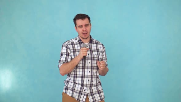 Middleaged Man Singing Into a Karaoke Microphone