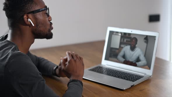 An African Guy Using Laptop for Video Call