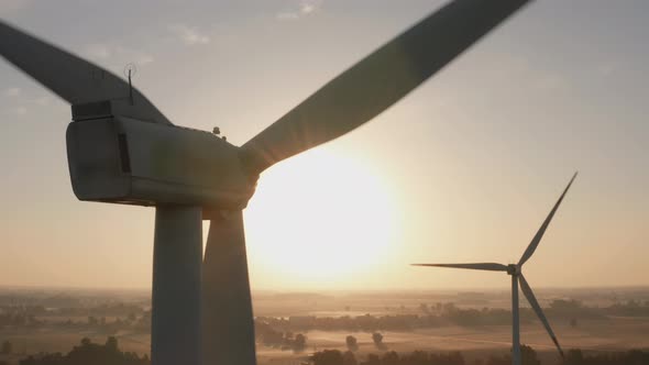 Ecofarm with a Wind Turbine on a Beautiful Field in the Fog