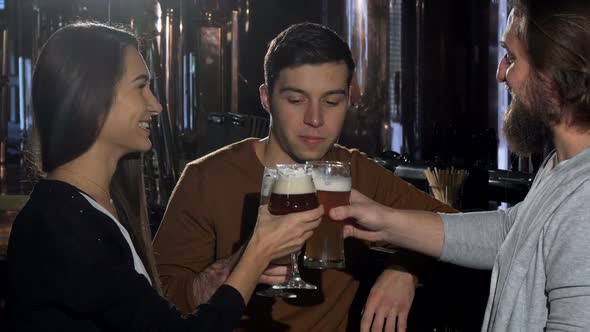 Group of Friends Enjoying Drinking Craft Beer at the Pub Together