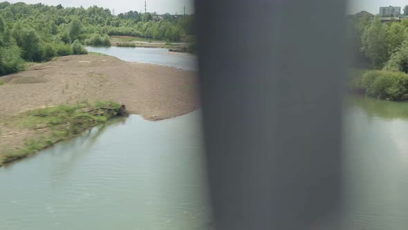 View From Window Highspeed Train on Landscape of Beautiful Nature River From Bridge and Forest