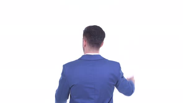 Rear View of Young Bearded Businessman Pointing Finger and Directing