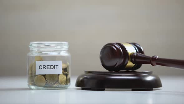 Coins Falling in Credit Glass Jar Table, Gavel Striking on Sound Block, Payment