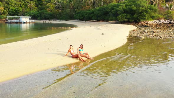 Girls look beautiful on idyllic bay beach break by blue water with white sand background of Koh Phan