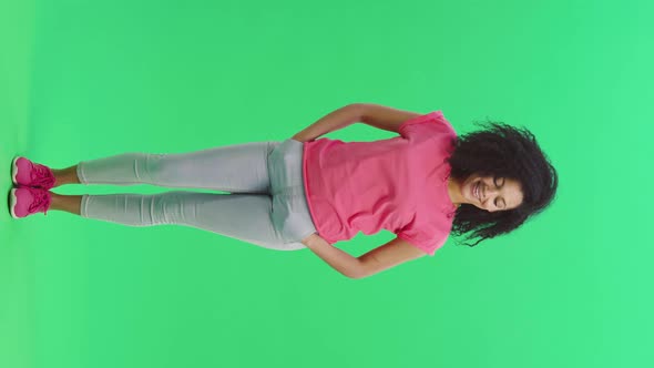 Portrait of Young Female African American Smiling Flirtatiously at the Camera and Winking