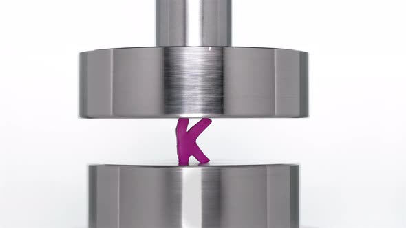 the Appearance of the Letter K When Lifting a Rod From a Hydraulic Press on a White Background