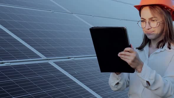 Inspector Engineer Woman Holding Digital Tablet Working in Solar Panels Power Farm