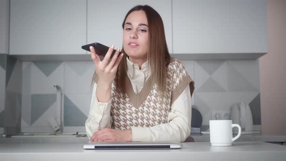 Woman Recording Voice with Smartphone at Home