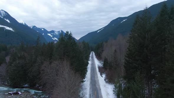 Aerial View From Above of Road By Fresh Water Flowing Down a River Creek