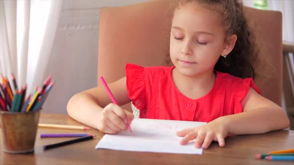 Cute Small Little Girl Artist Playing Alone Drawing Coloring Picture with at Home Relaxing Sits in