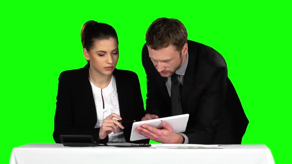 Business Man and Woman Using Laptop in Office Lobby. Green Screen