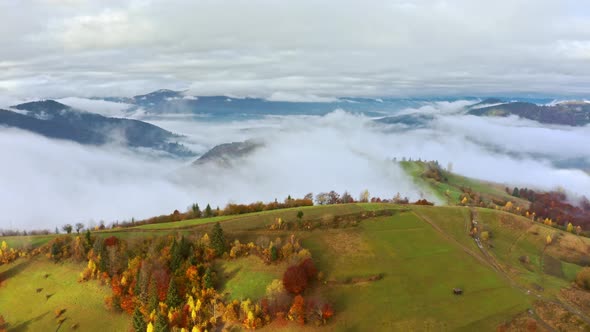 Flight Through Blue Sky with Clouds Over Mountain