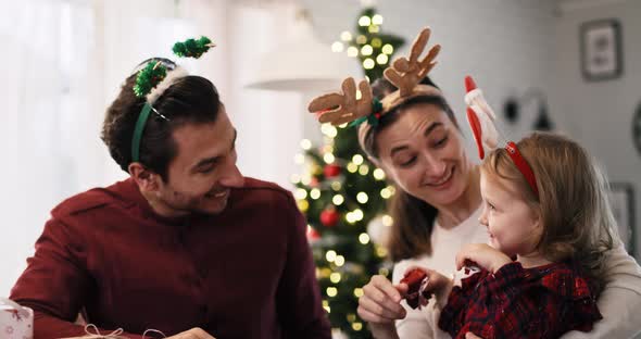 Handheld video shows of family celebrating Christmas together