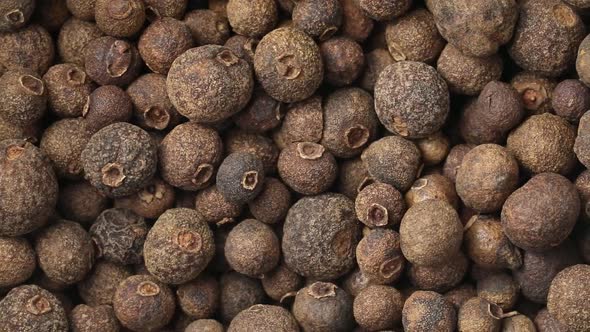 Dried whole allspice berries close up full frame as a background 