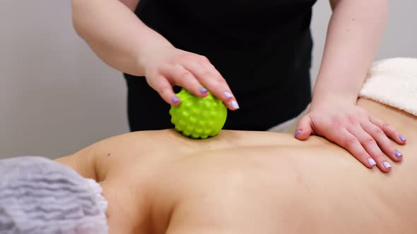 Woman at the Physiotherapy Receiving Ball Massage From Therapist