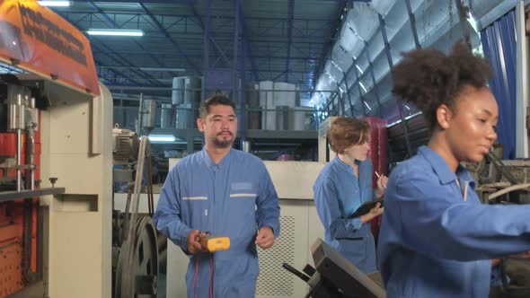 Engineer teams inspect machines' electric current at the industry factory.