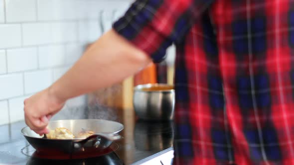 Man preparing food in kitchen at home 4k