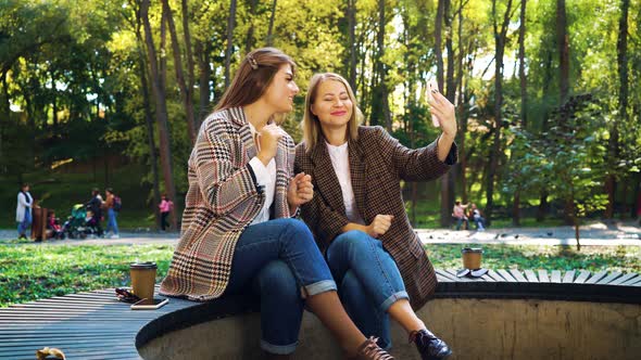 Female Bloggers Recording Video in Park