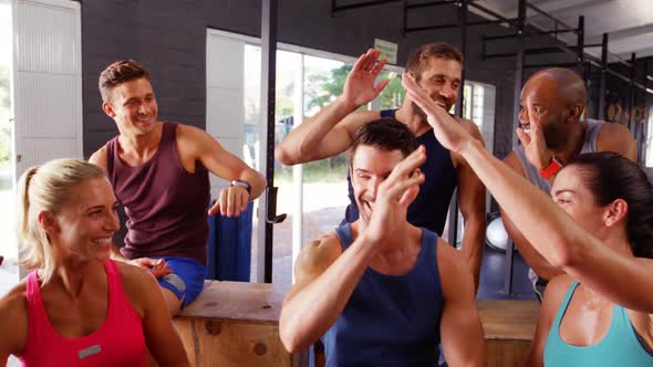 Group of friends giving high five to each other