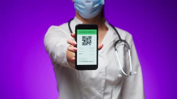 Woman Doctor in Medical Uniform Showing Vaccination Passport with Qr Code on Phone International