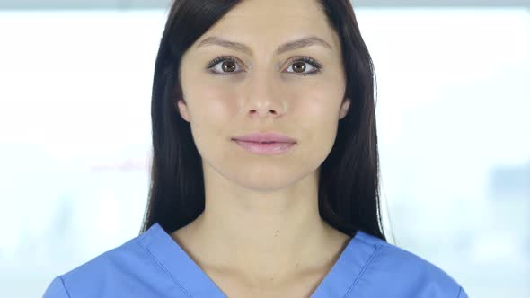 Close Up of Doctor Looking At Camera in Clinic