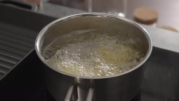 Slow Motion Gimbal Shot of Fettuccine Boiling in Saucepan