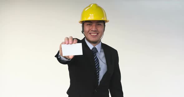 Businessman  in Construction Helmet Showing Business Card