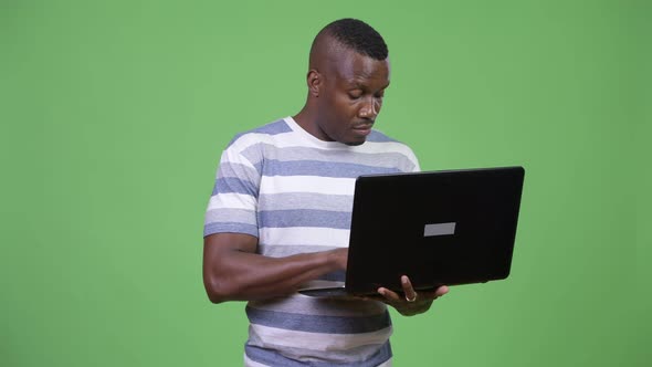 Young Happy African Man Using Laptop