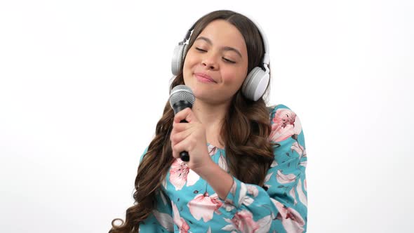 Smiling Child Singer Artist Sings Songs Into Microphone Listen Music in Headphones Vocal