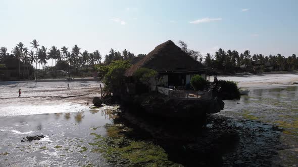 The Rock Restaurant in Ocean Built on Cliff at Low Tide on Zanzibar Aerial View