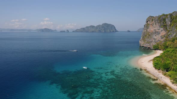 Aerial View of First Tourists Boats Arriving the Tropical Beach of Dilumacad or Helicopter Island