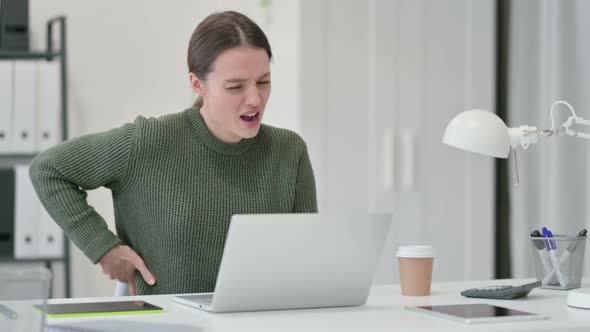 Young Woman Having Back Pain at Work